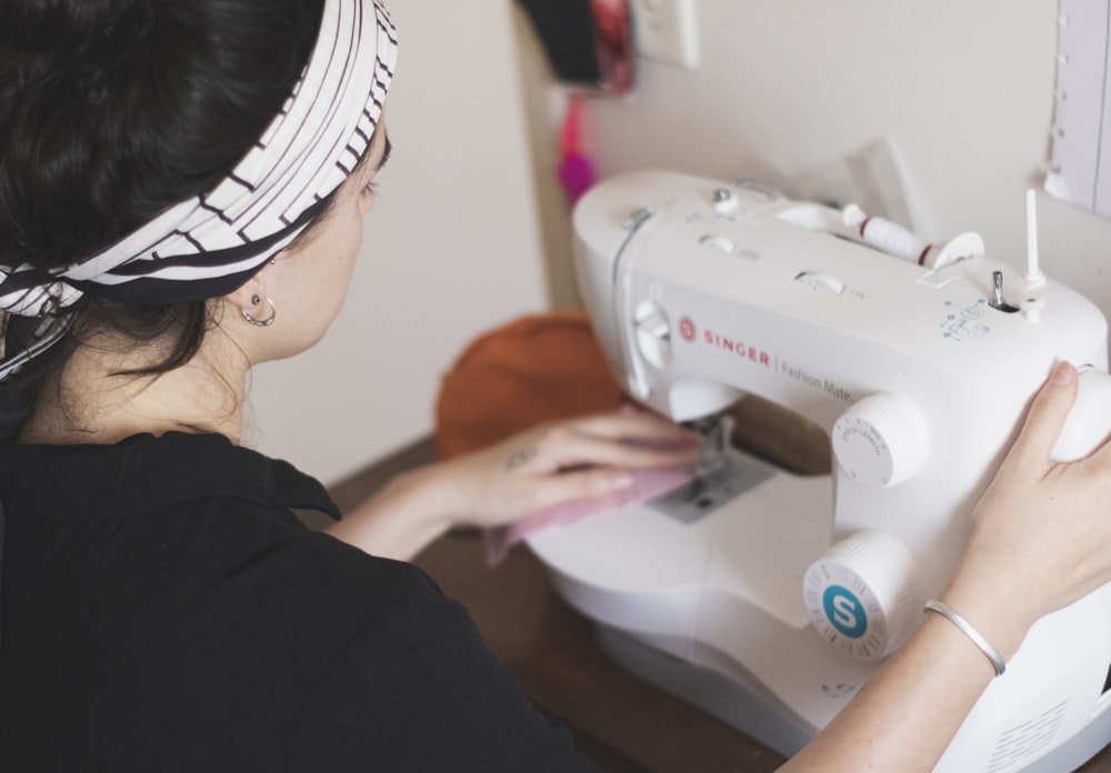 woman in black long sleeve shirt sewing