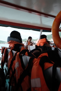 A captain checking safety gear on board with coletes and radio visible