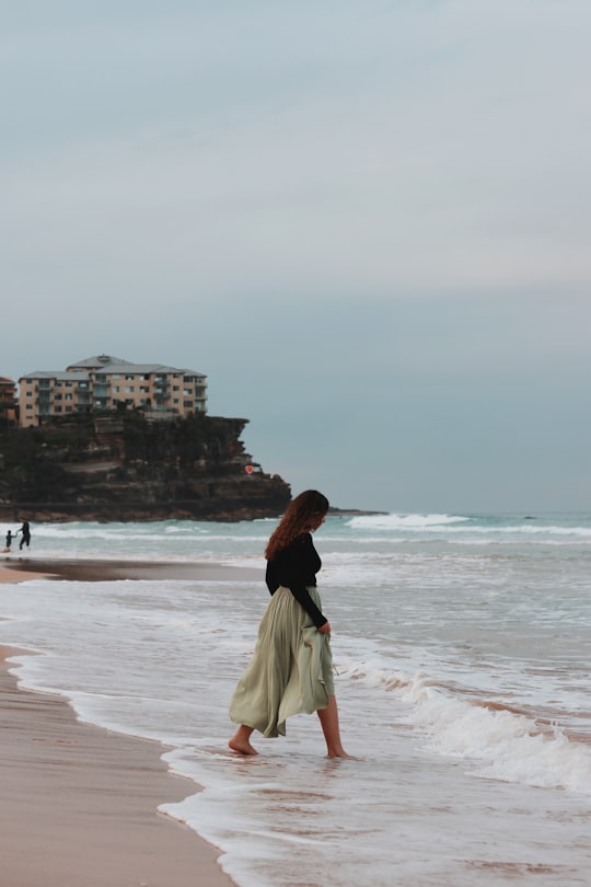 woman in white skirt standing on beach during daytime in Manly Beach Australia