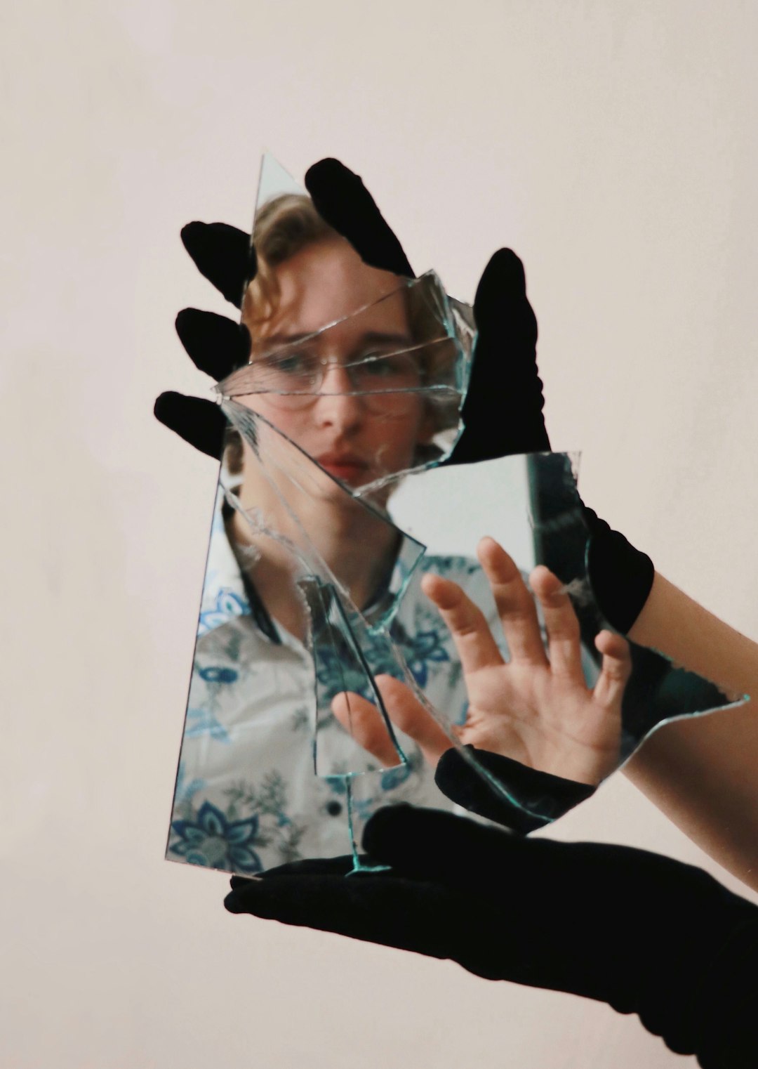  woman in black shirt covering face with hands mirror