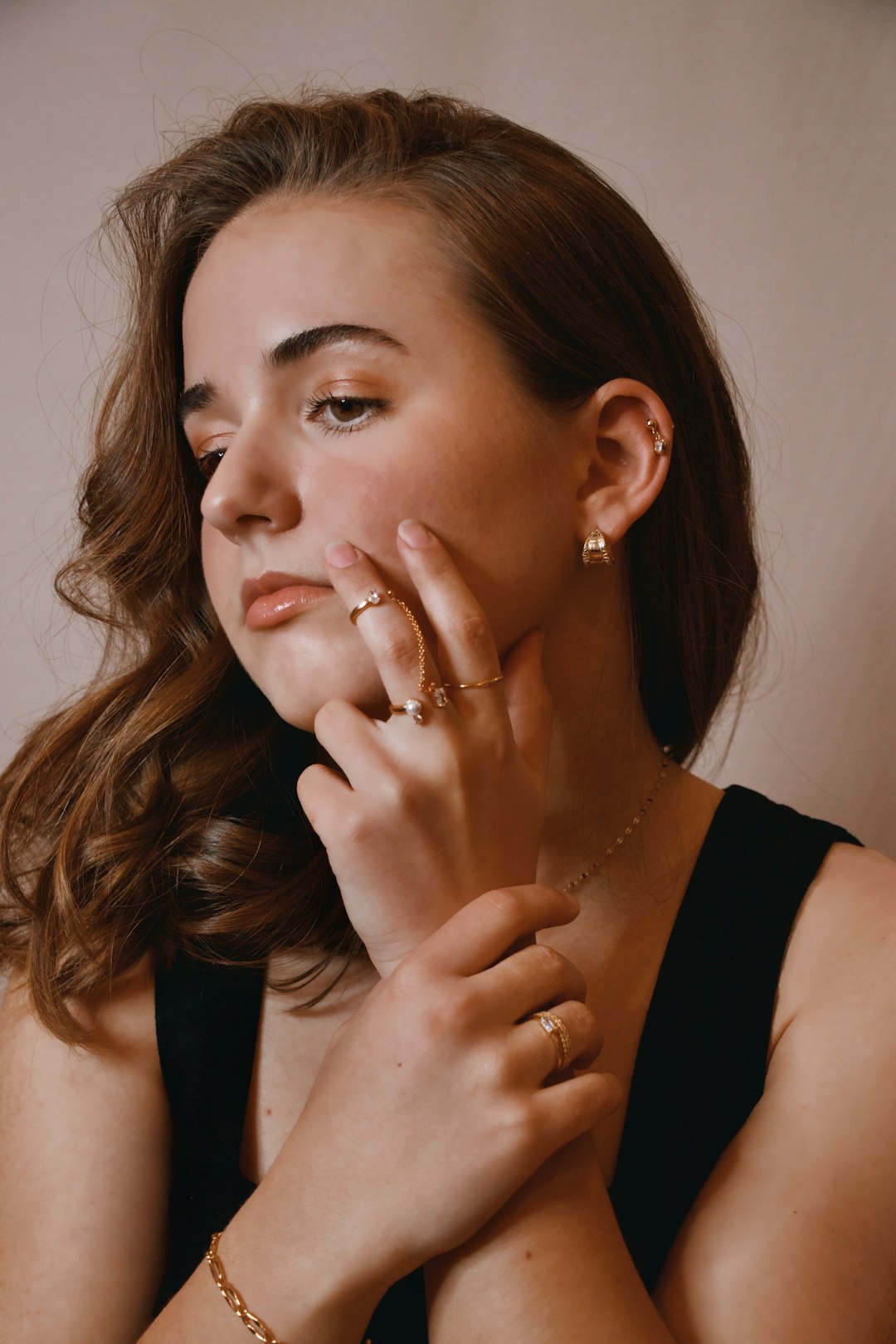 woman in black tank top wearing gold ring