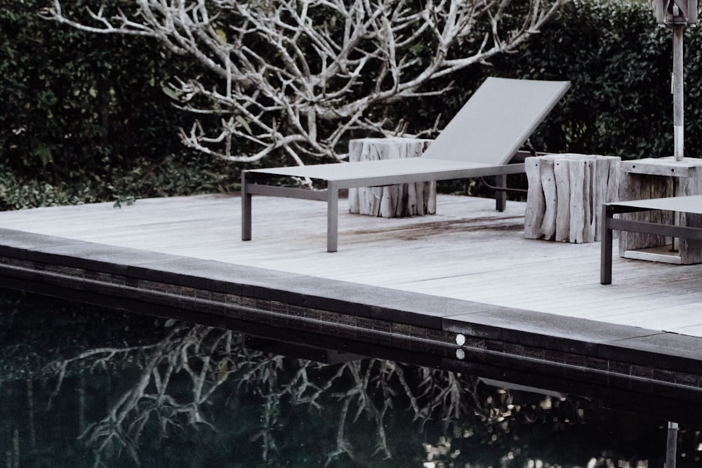 brown wooden bench near body of water during daytime