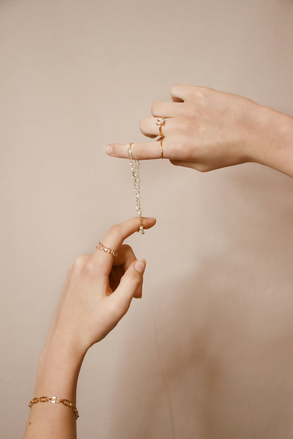 person holding silver chain necklace