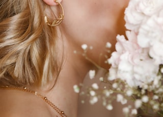 woman with blonde hair wearing gold earrings