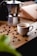 Close-up of a steaming cup of espresso made from Mokaflor capsules on a rustic wooden table.