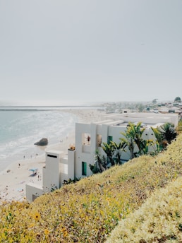 white concrete building near sea during daytime