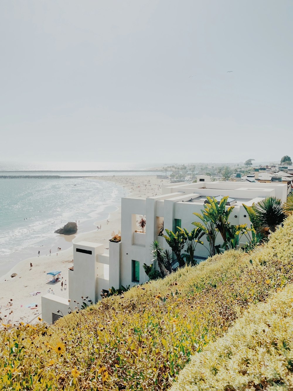 white concrete building near sea during daytime