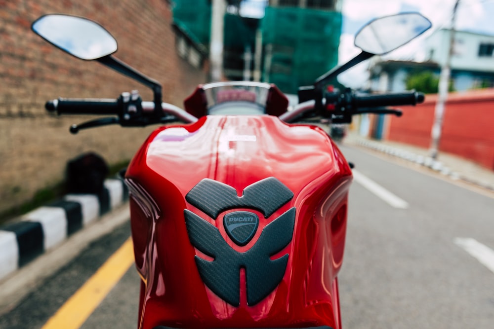 red and black motorcycle on road during daytime