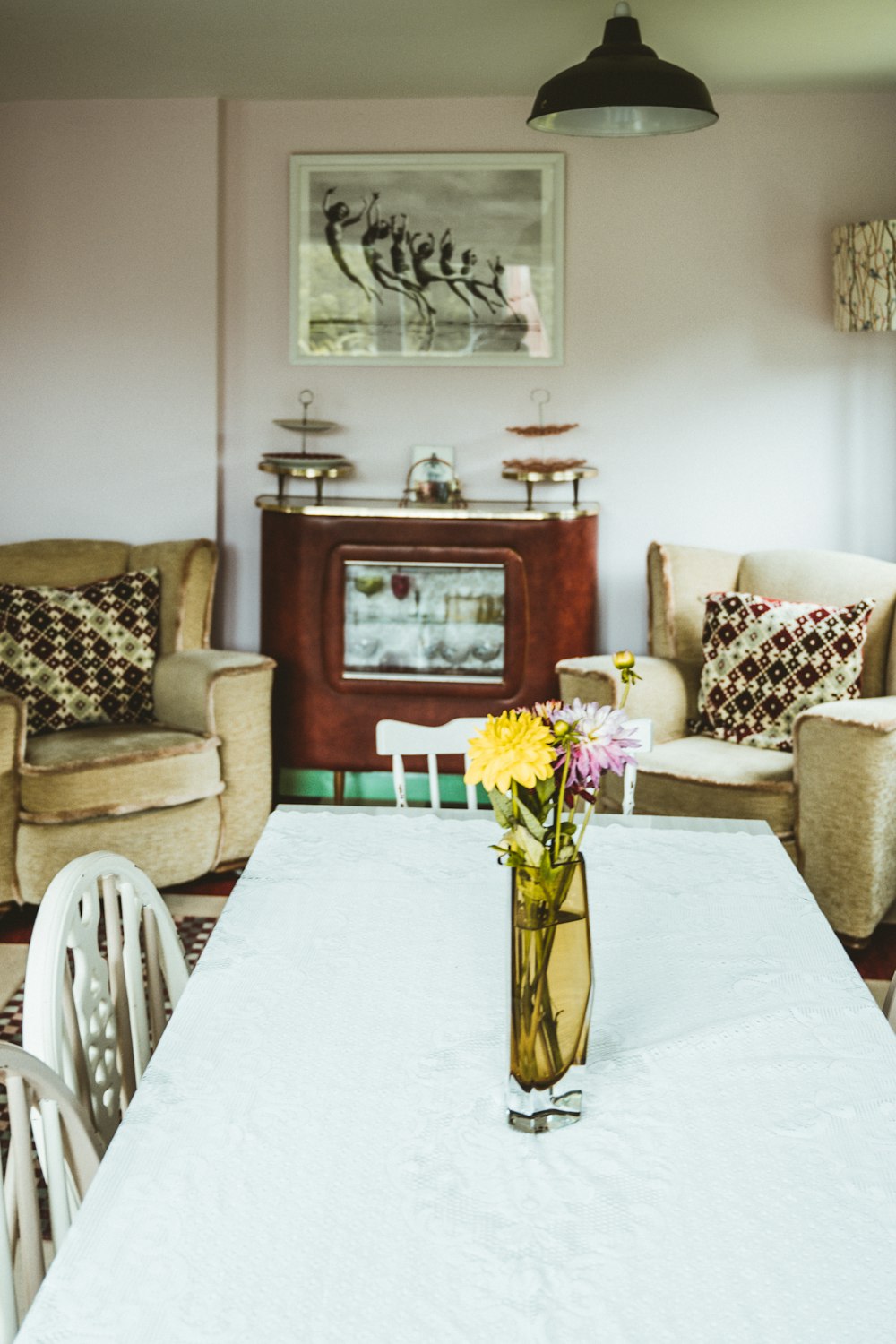 yellow and white flower on clear glass vase on table