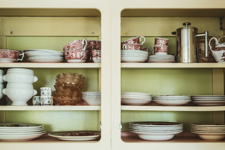 Description: white ceramic bowl on brown wooden cabinet