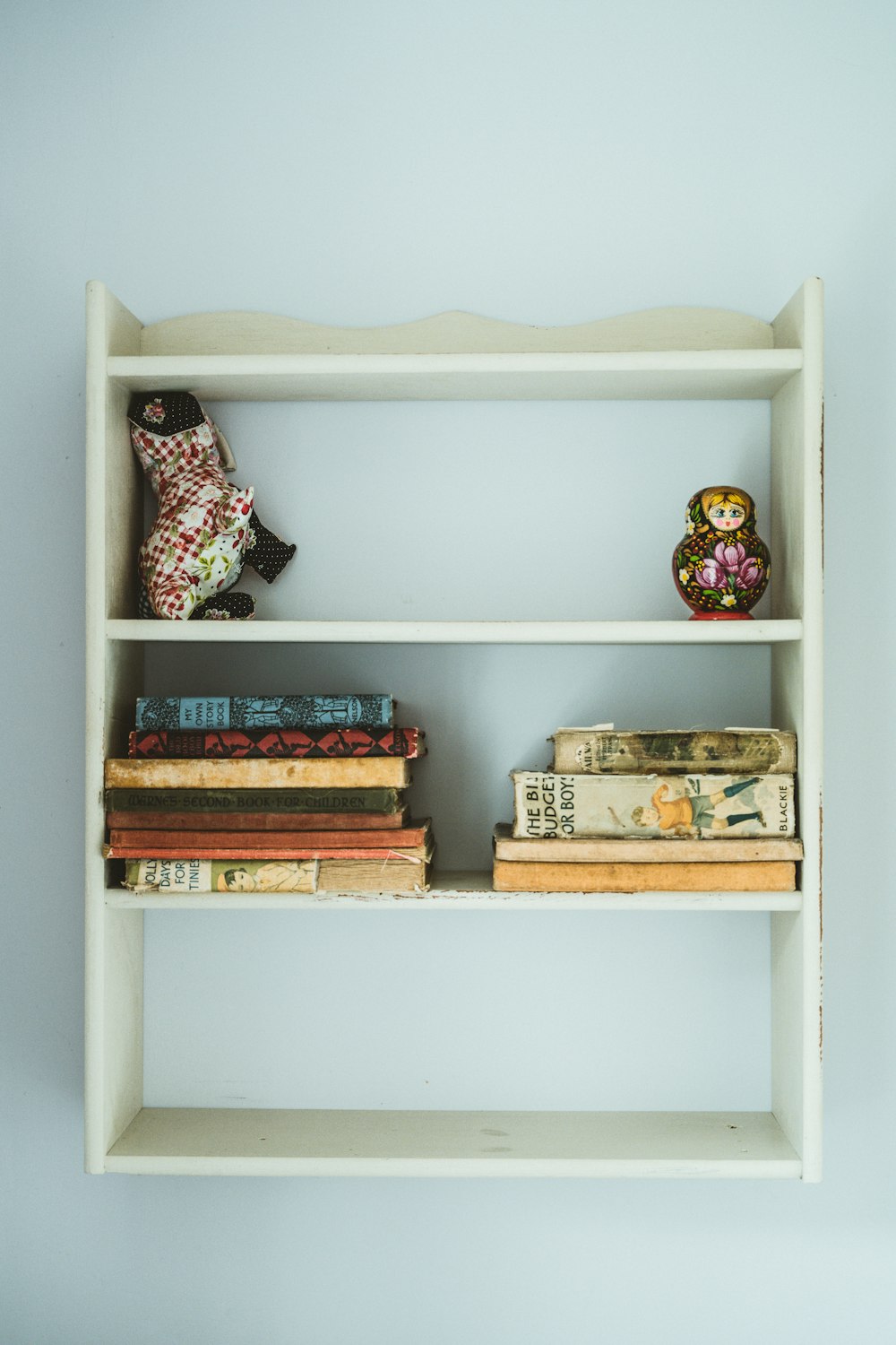 books on white wooden shelf