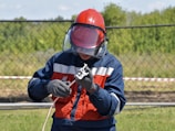 boy in red and black jacket wearing helmet