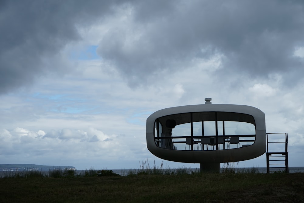 black round frame on green grass field under white clouds during daytime