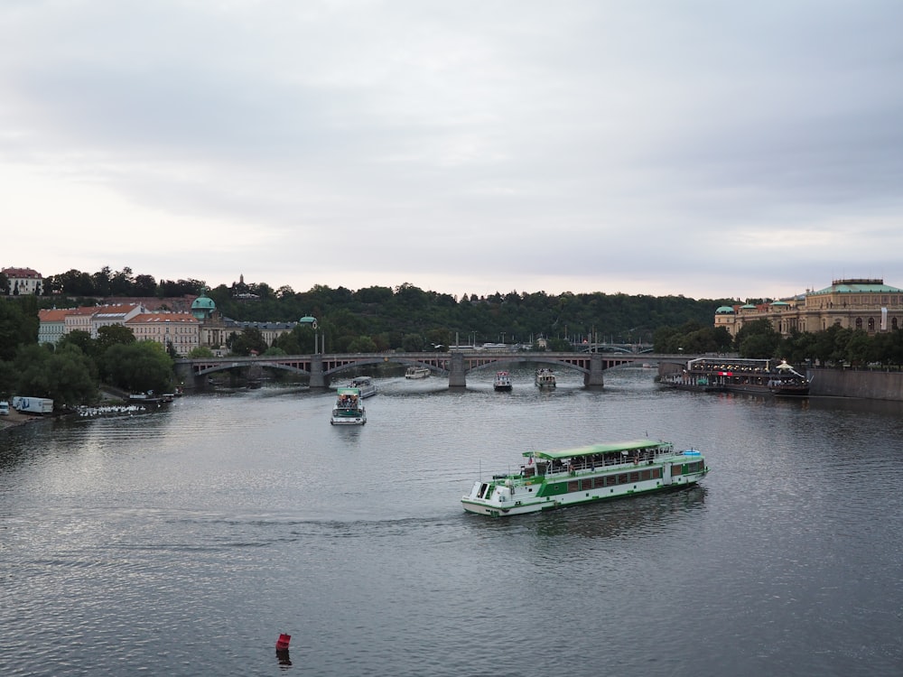 green and white boat on water during daytime