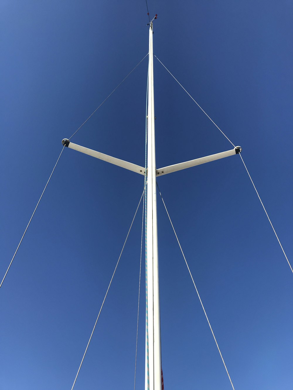 white metal electric post under blue sky during daytime