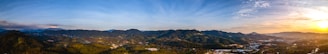 A panoramic view of the smoky mountains bathed in golden sunset light.