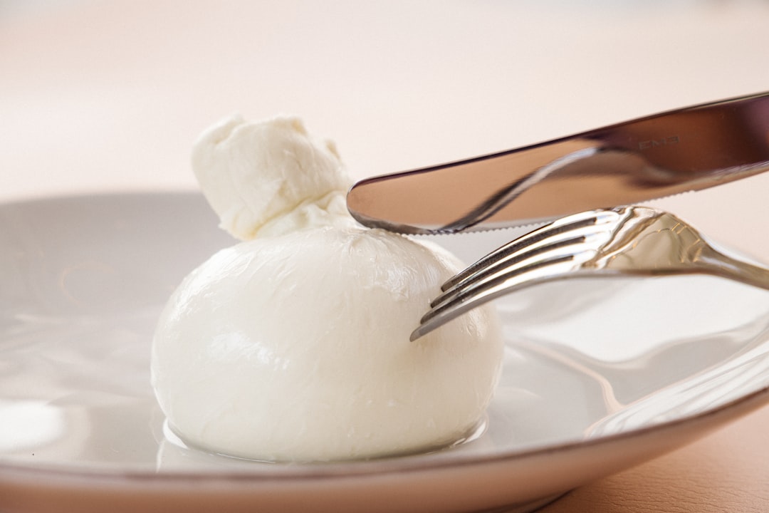 stainless steel fork on white ceramic plate