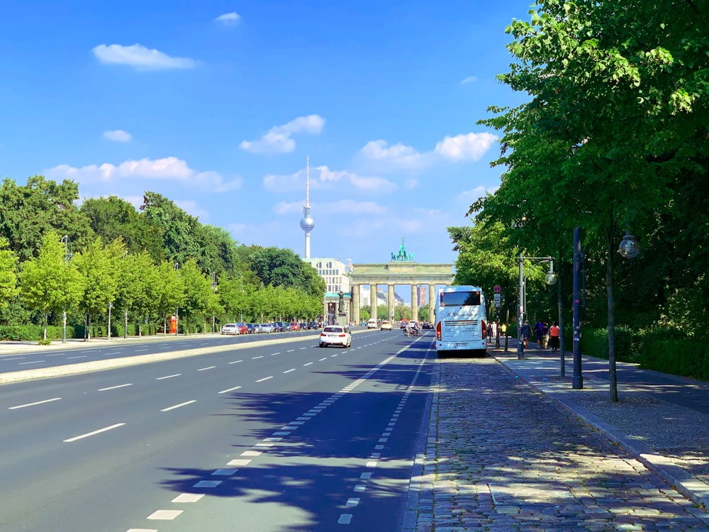 white bus on road during daytime