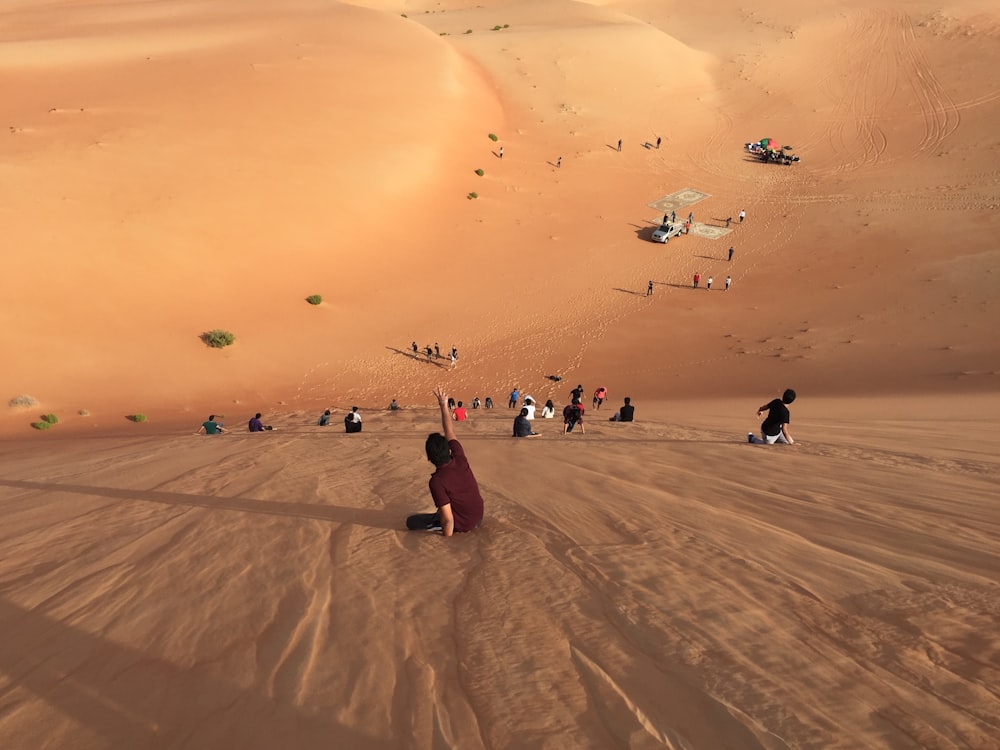 people walking on sand dunes