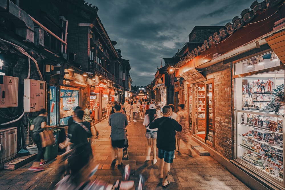 people walking on street during night time