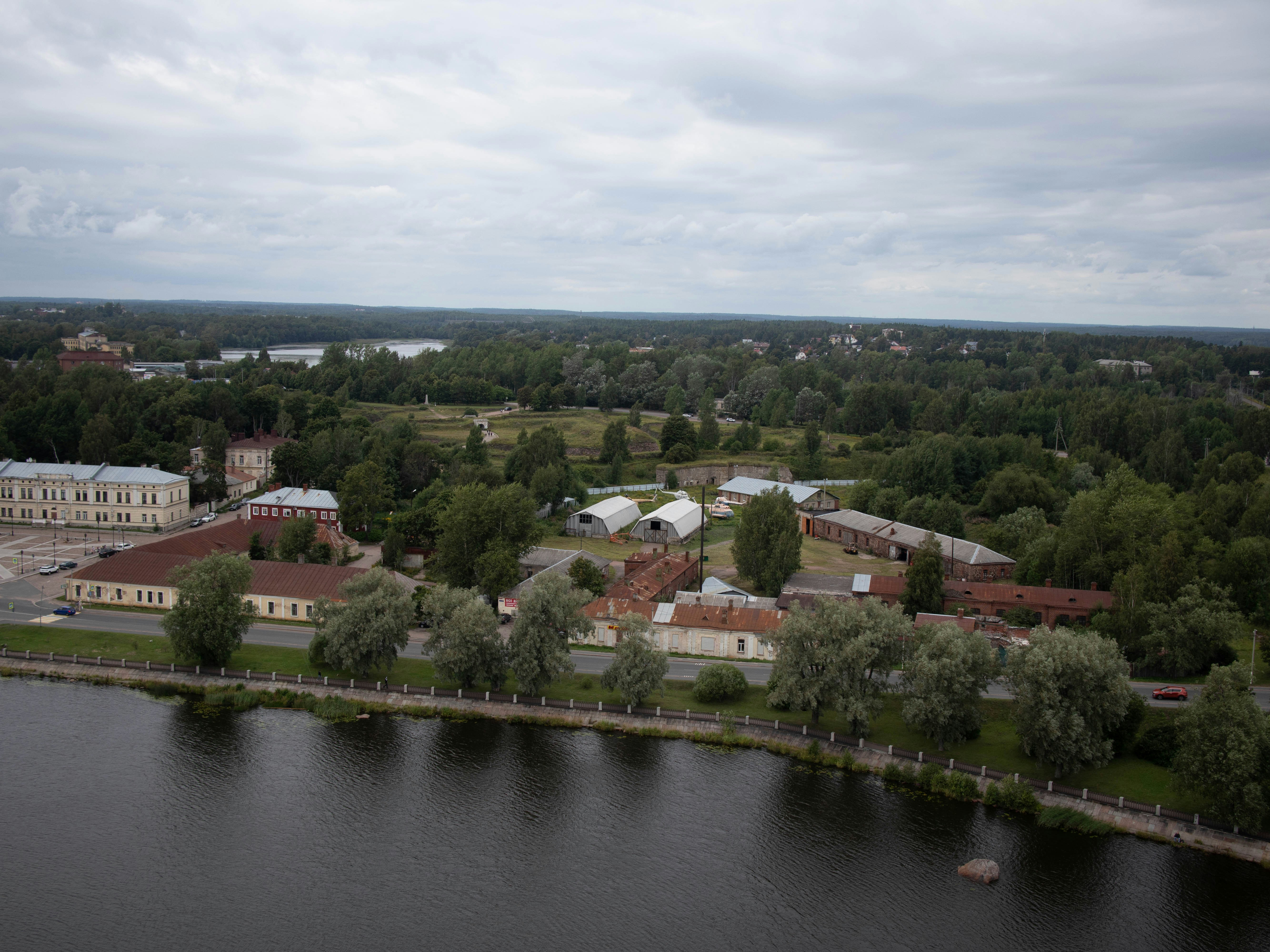 aerial view of green trees and houses near river during daytime
