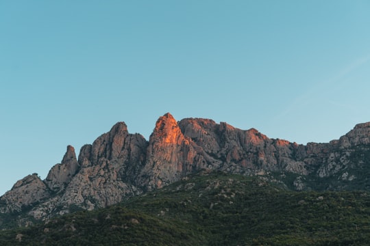 brown rocky mountain under blue sky during daytime in Regional Natural Park of Corsica France