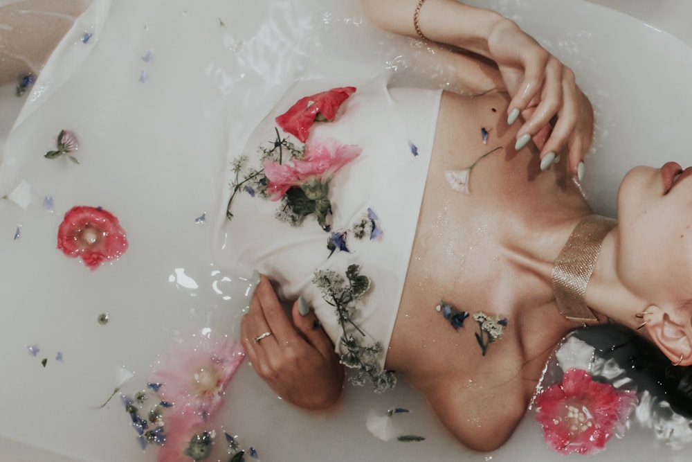 woman with red rose petals on white printer paper