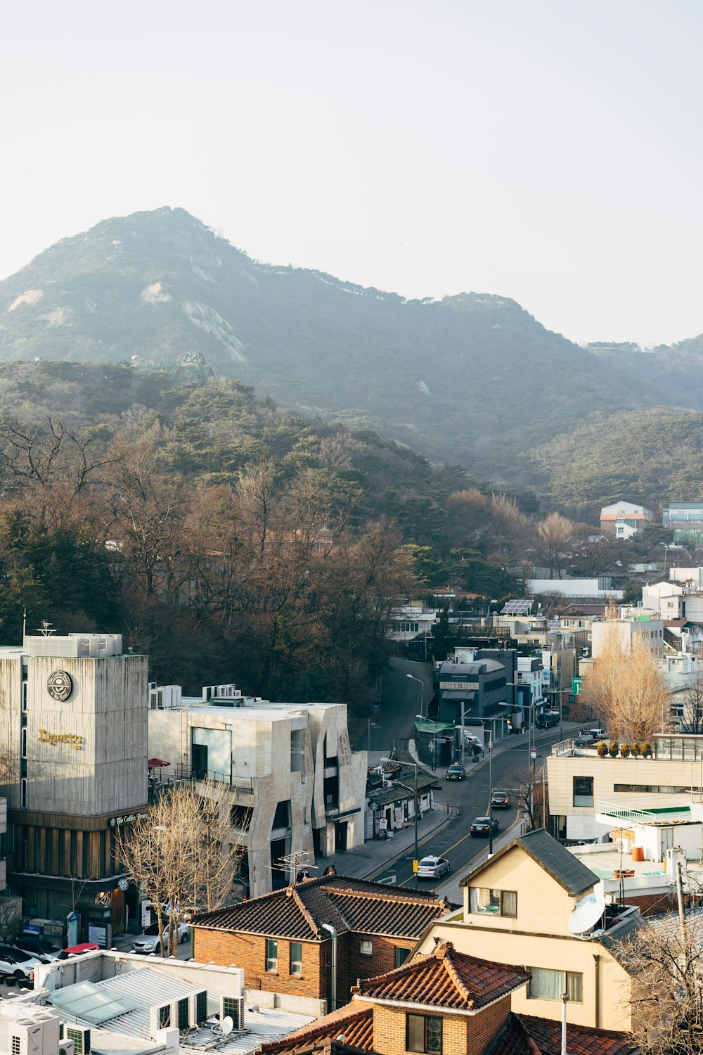 aerial view of city buildings near mountain during daytime