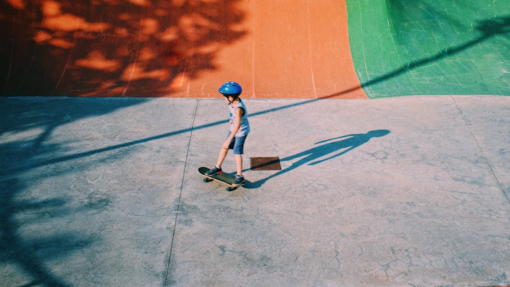 boy in blue t-shirt and black shorts playing basketball