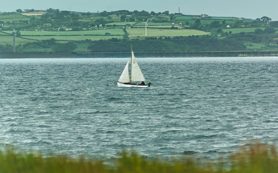 white sailboat on body of water during daytime