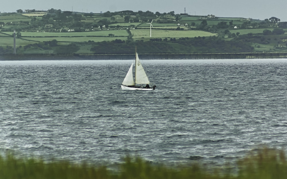 white sailboat on body of water during daytime