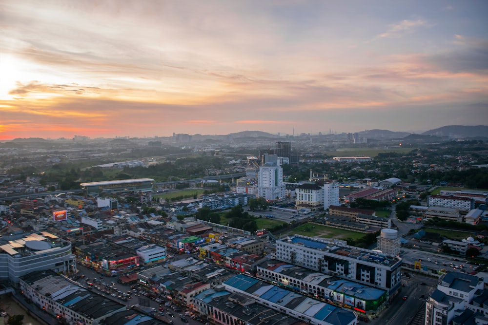 city with high rise buildings under white clouds during daytime