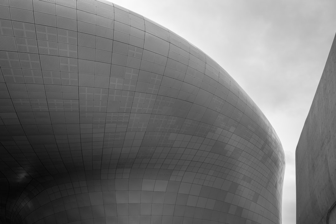 grayscale photo of round concrete building