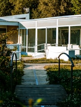 A modern school building with welcoming entrance and green surroundings.