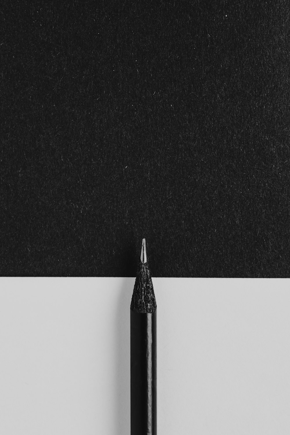 a black pen sitting on top of a piece of paper