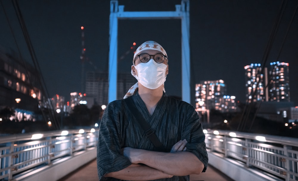 man in black and gray stripe long sleeve shirt wearing white mask