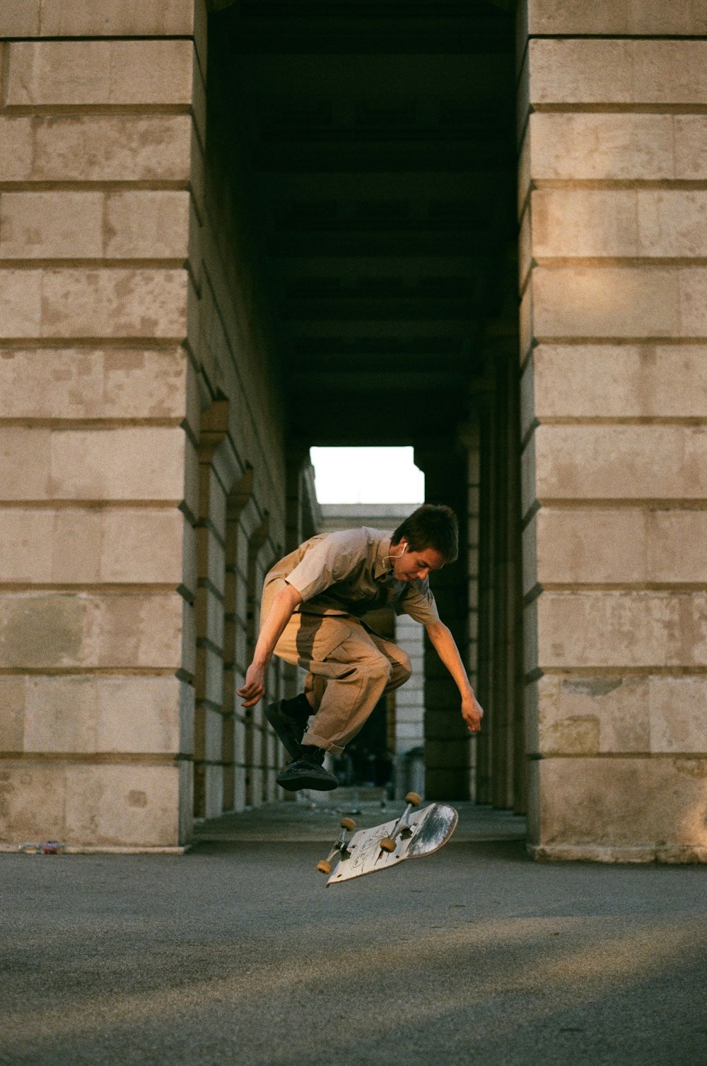 man in green t-shirt and black pants sitting on concrete stairs