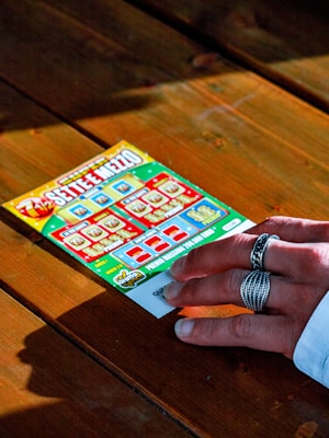 person in white long sleeve shirt holding white and red box