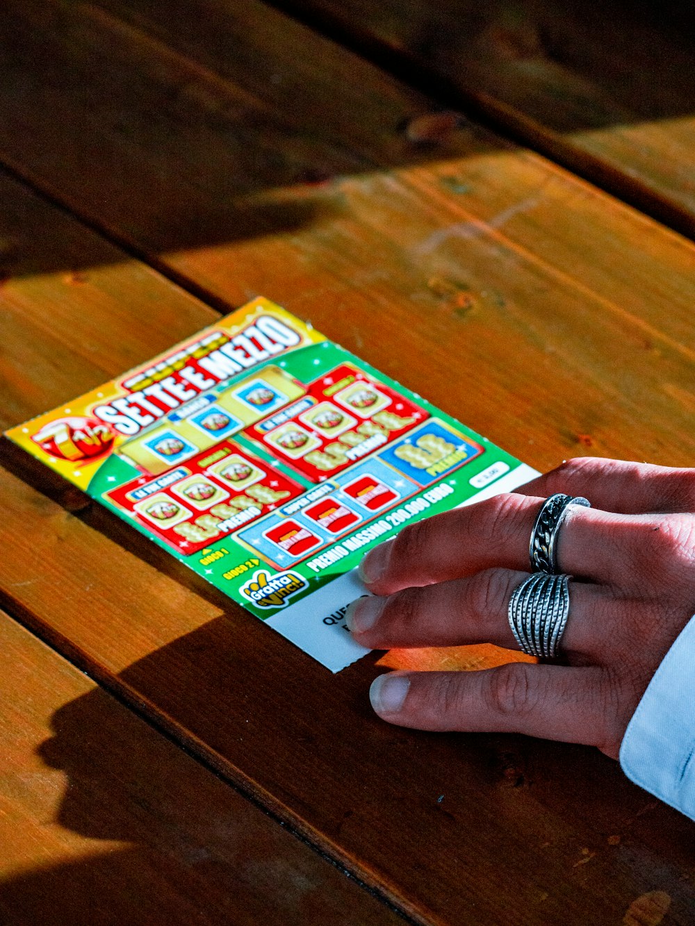 person in white long sleeve shirt holding white and red box