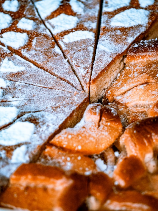 Close-up of a 12-inch luxury vintage Japanese sponge cake with delicate powdered sugar dusting.