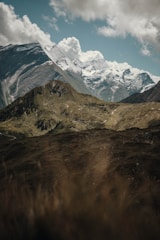 A scenic mountain landscape with mist and a blue sky, embodying adventure.