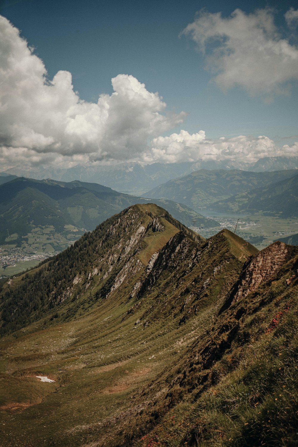 brown and green mountains under white clouds and blue sky during daytime