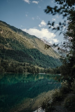 A serene mountain retreat surrounded by lush greenery and clear skies.