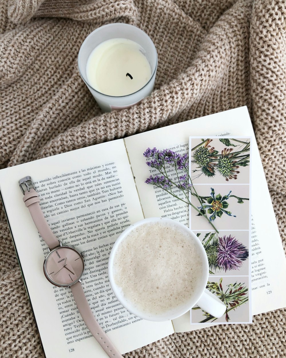 white ceramic mug beside white book