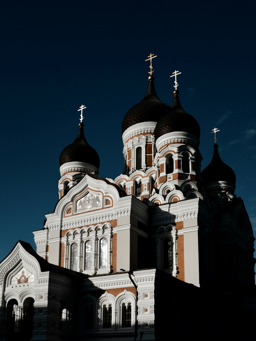 white and black concrete church under blue sky during daytime