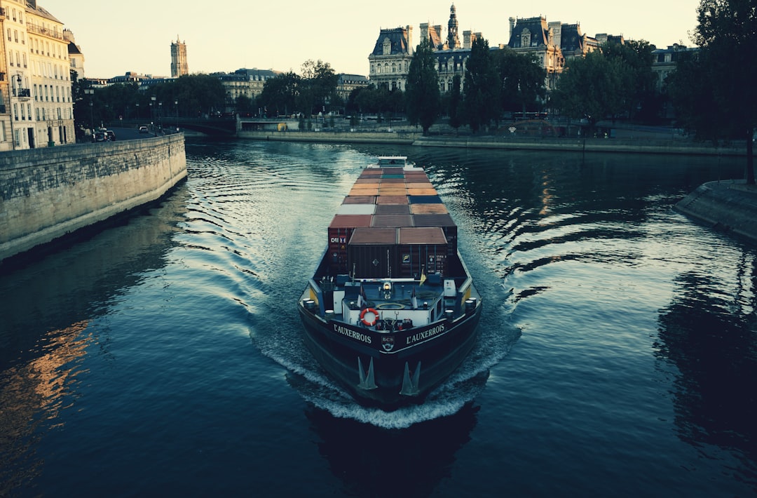 black boat on body of water during daytime