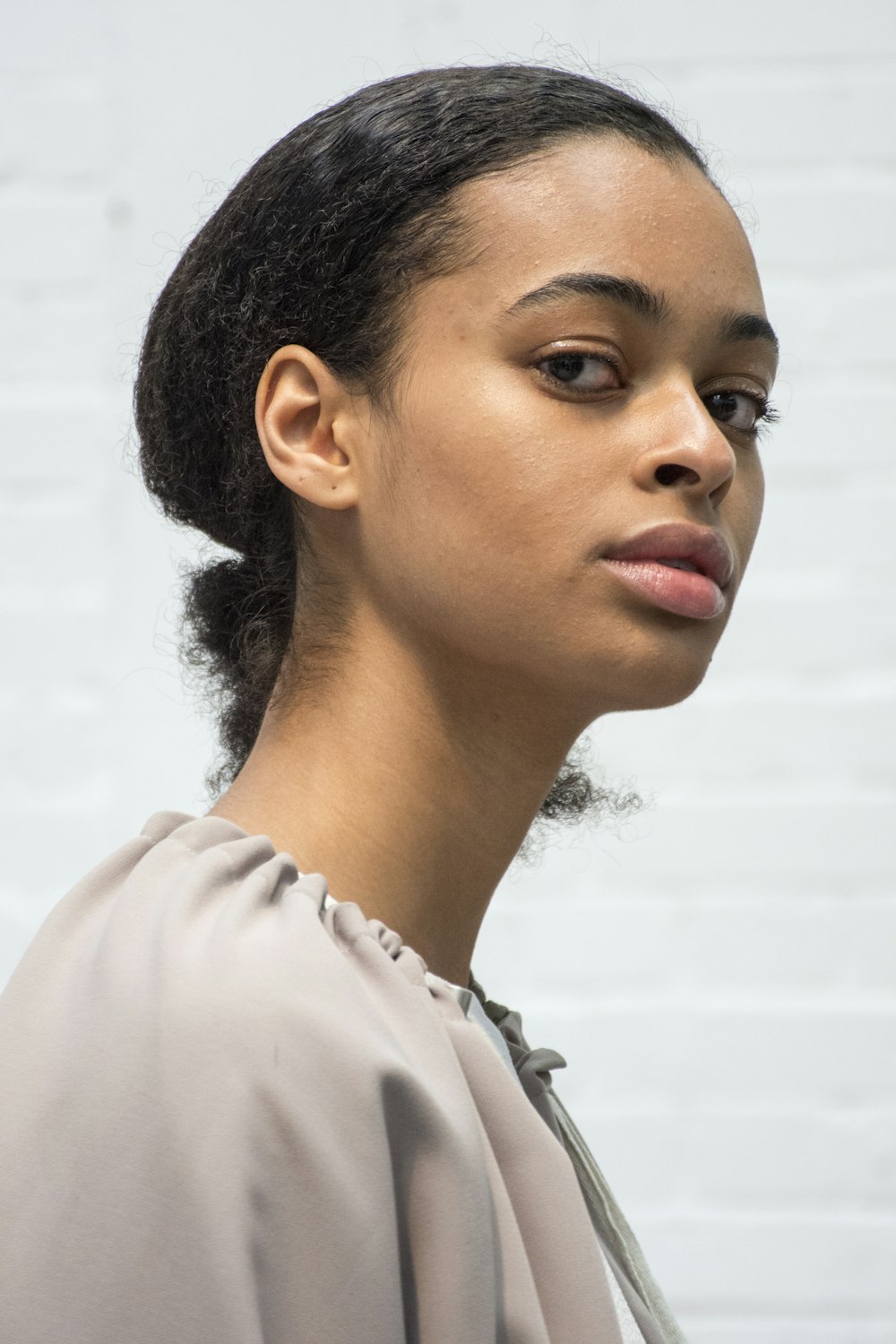 woman in white shirt looking down