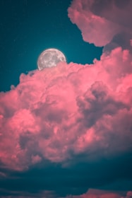 white clouds and moon during night time