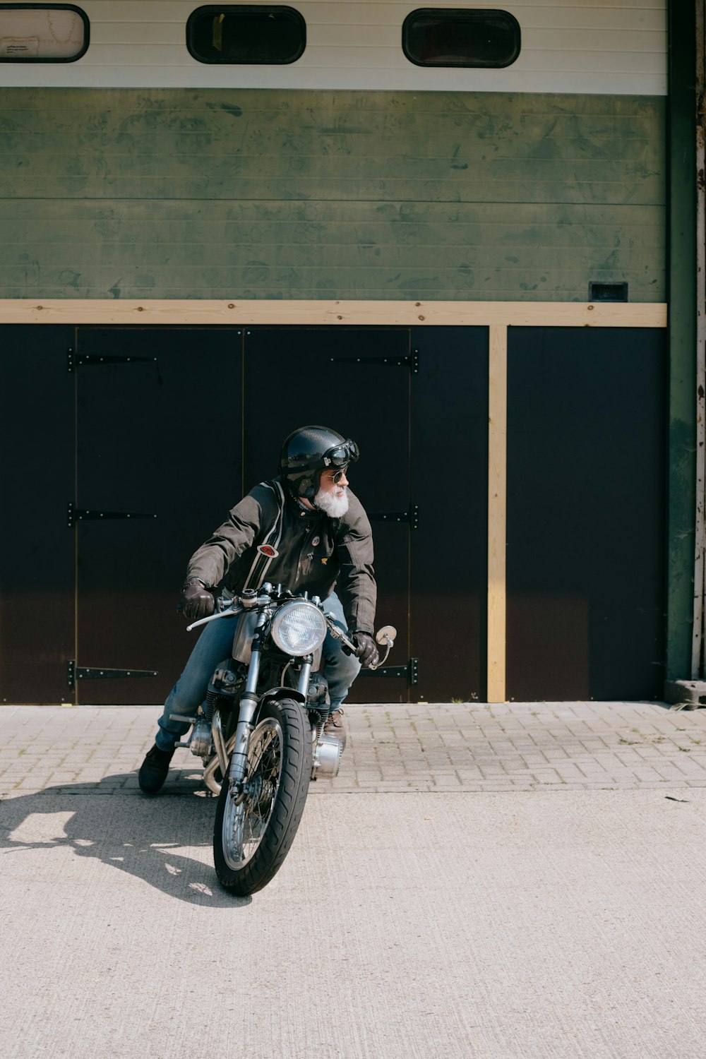 man in black jacket riding motorcycle