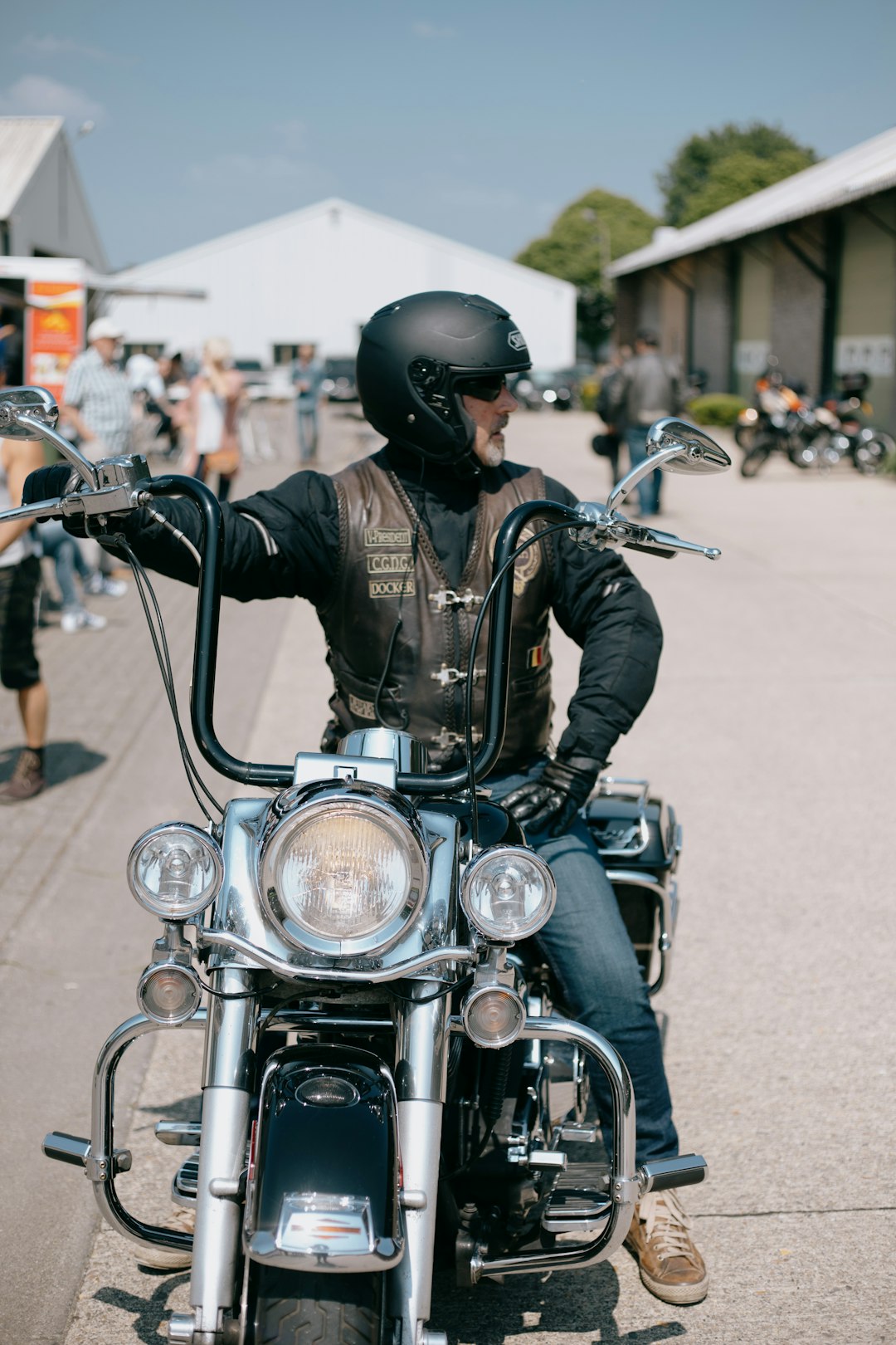 man in black leather jacket riding on black motorcycle during daytime